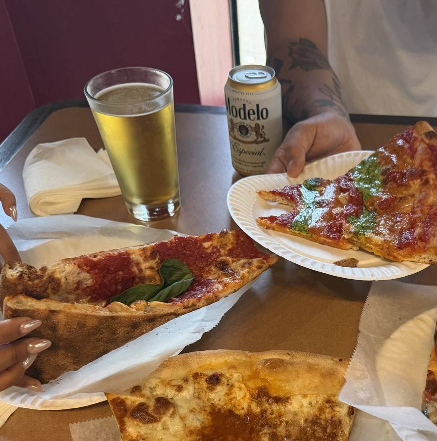 A cold beer and slices on the table at Ray's Corner